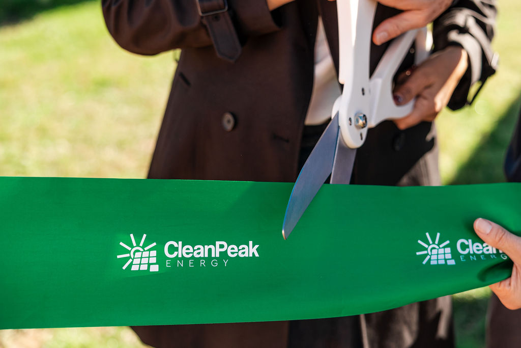 scissors cutting green ribbon
