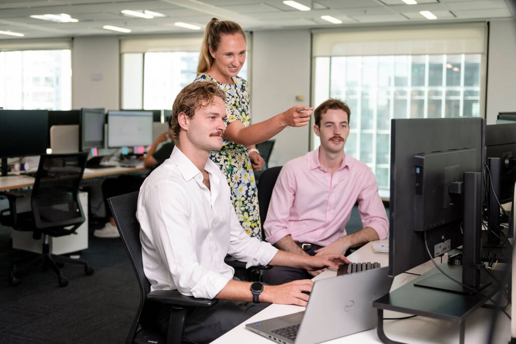 three cleanpeak energy workers collaborating at their desk